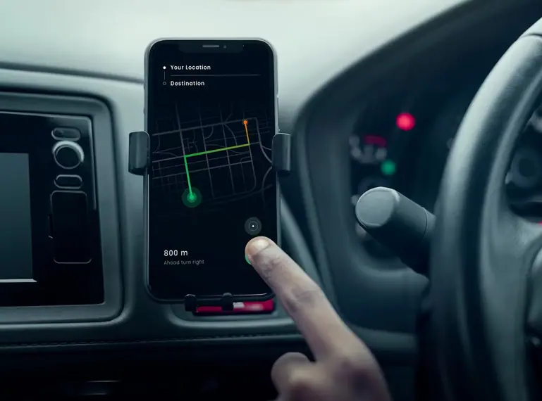 Smartphone GPS navigation mounted on car dashboard